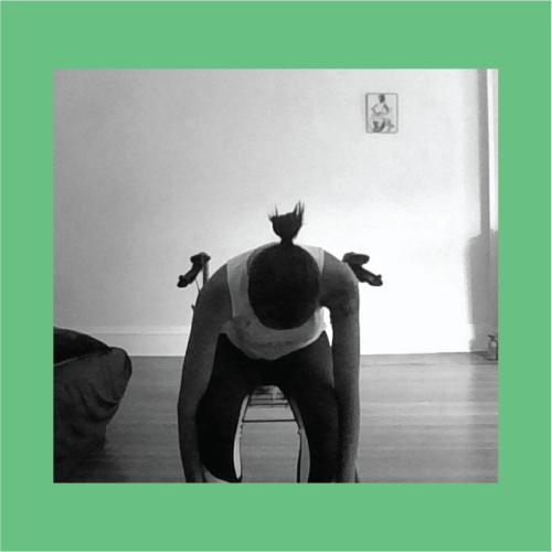 A black and white image on a green background of a woman sitting in a chair as she reaches to bend down to her toes.