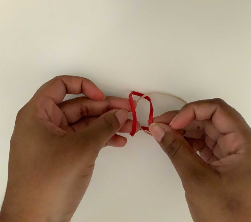 Placing a rubber band through another rubber band