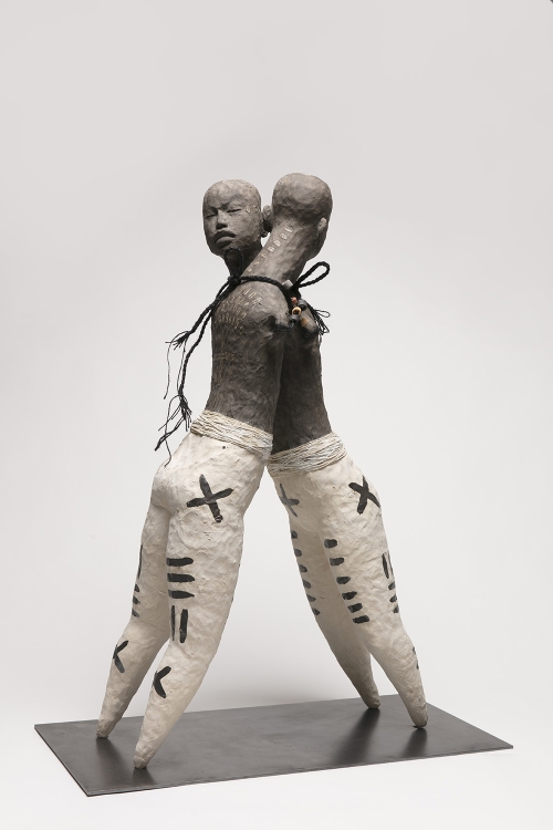 Clay sculpture of two armless figures interlocked and tied to each other