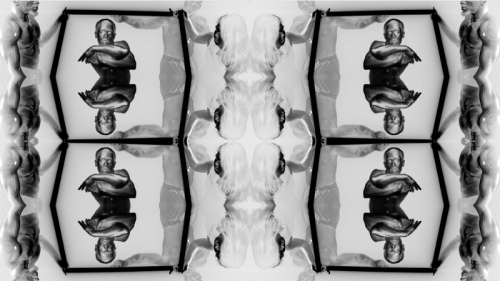A black and white polarized image featuring complex horizontal and vertical mirroring of dancers and dark rods.  