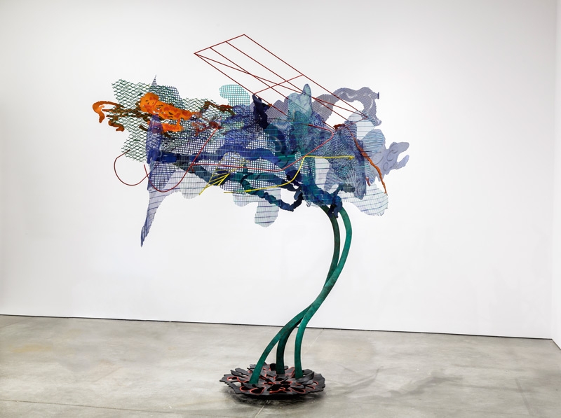 A large-scale, colorful sculpture of bronze and steel resembling a tree or flower.