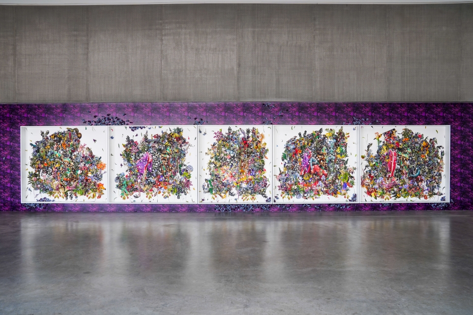 Five panels with white backgrounds and multicolored floral imagery concentrated in the middle are hung horizontally against a repeating purple-patterned wall with blue violet butterflies arranged around the panels.