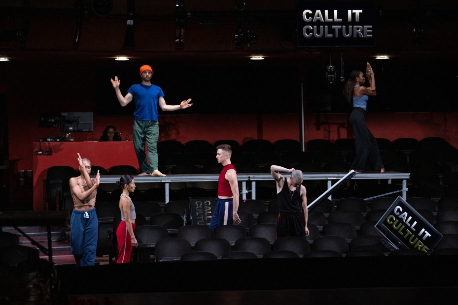 "Call it culture" sign in the back right with dancers on a stage.
