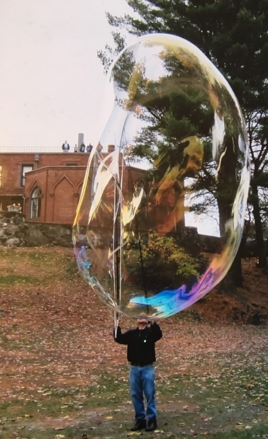 Man blowing giant bubble