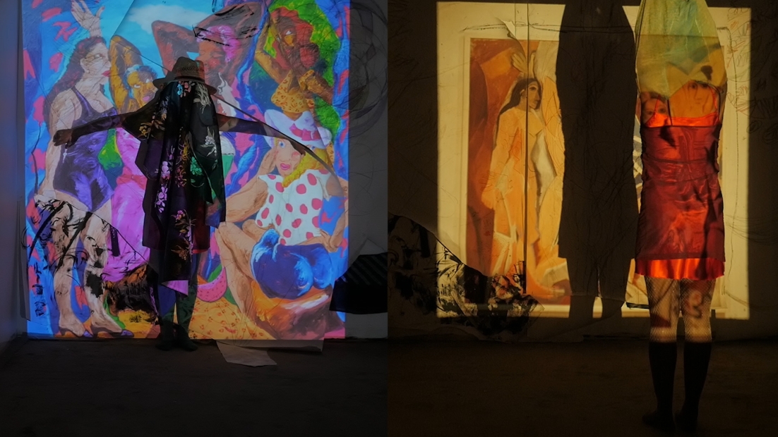 Two feminine figures performing in front of a wall projection of paintings depicting women