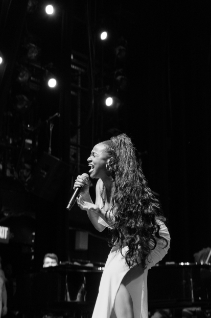 Black and white photo of woman singing on stage