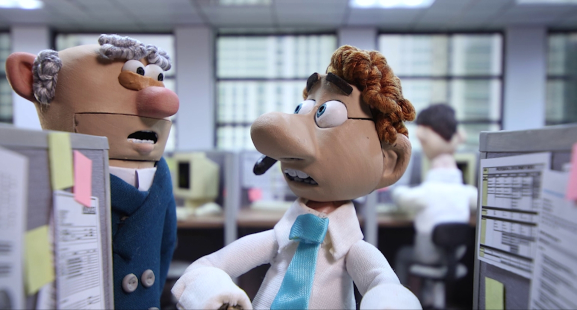 Two Claymation people talking in an office setting