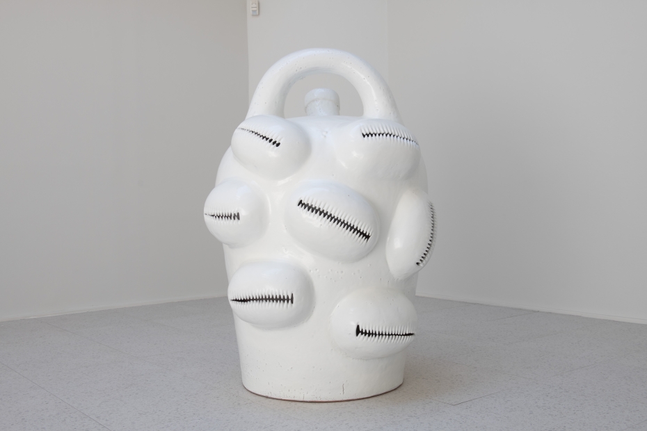 a white jug-shaped sculpture in white