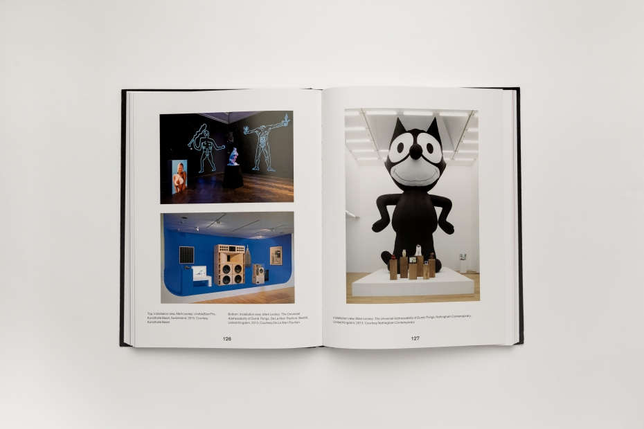 A book spread of three large installation images of exhibitions, including one with a large sculpture of Felix the Cat.