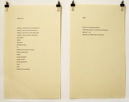 Two parchment- colored pages containing different text in black type hang side by side with silver pushpins and black binder clips.