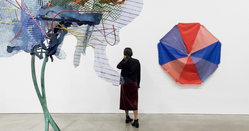 Vistior looking at art in ICA Collection: New Acquisitions exhibtion