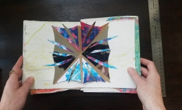 Opening a book to show a bright pop-up card