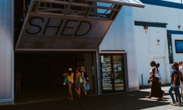 People walking into the Watershed building on a sunny day.