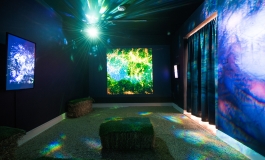 Blue and green room installation with light projection and screens