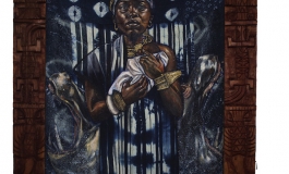 A painting on indigo-dyed fabric depicts a woman holding an infant as she looks directly at the viewer. It is flanked by carved wooden pieces.