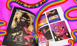 A hand holding up a zine called "Over the Rainbow"