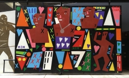 A wall-size work features colorful cutout figures, hearts, Xs, and other dynamic shapes.