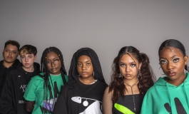 Six teenagers wearing Virgil Abloh ICA clothing stare directly at the camera in front of a neutral background.