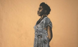 A drawing in Conte crayon on butcher paper depicts a Black woman in a patterned dress and black sneakers with white stripes standing in profile, facing left. She holds a box cutter behind her back.