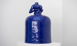 Blue ceramic vessel of a woman's torso with a large skirt