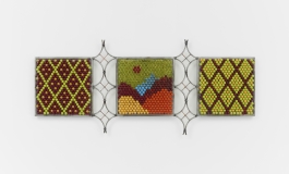 3 square sculptures with lime, sky blue, cranberry, and hanza yellow beads. The panels are joined by welded curved poles, appearing like a terrace structure. The beads are organized in an argyle-like fashion.