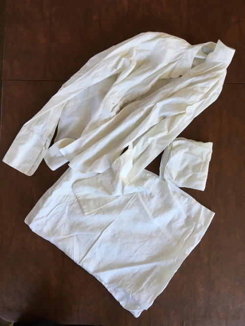 A white button-shirt, light-colored fabric, and a white pillowcase.