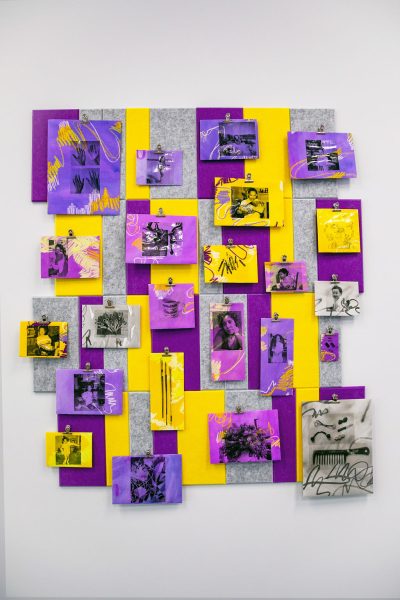 Purple and yellow paper with images printed on them adhered to grey board