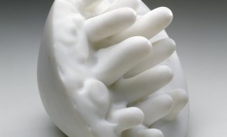 A hemispheric white marble sculpture with protruding, rounded spikes.