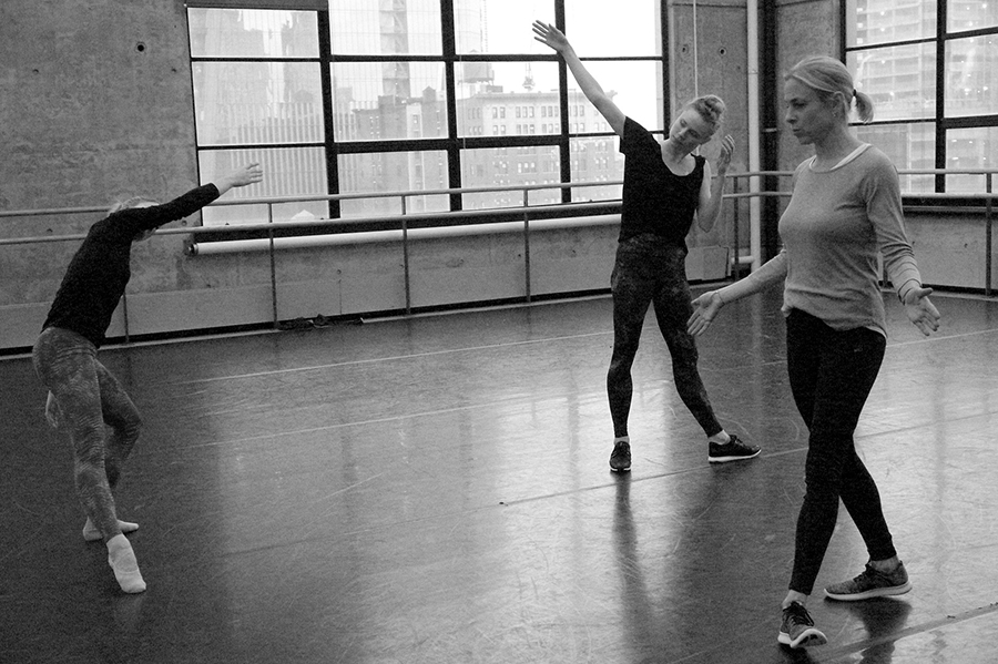 A black and white photo of three dancers in a studio.
