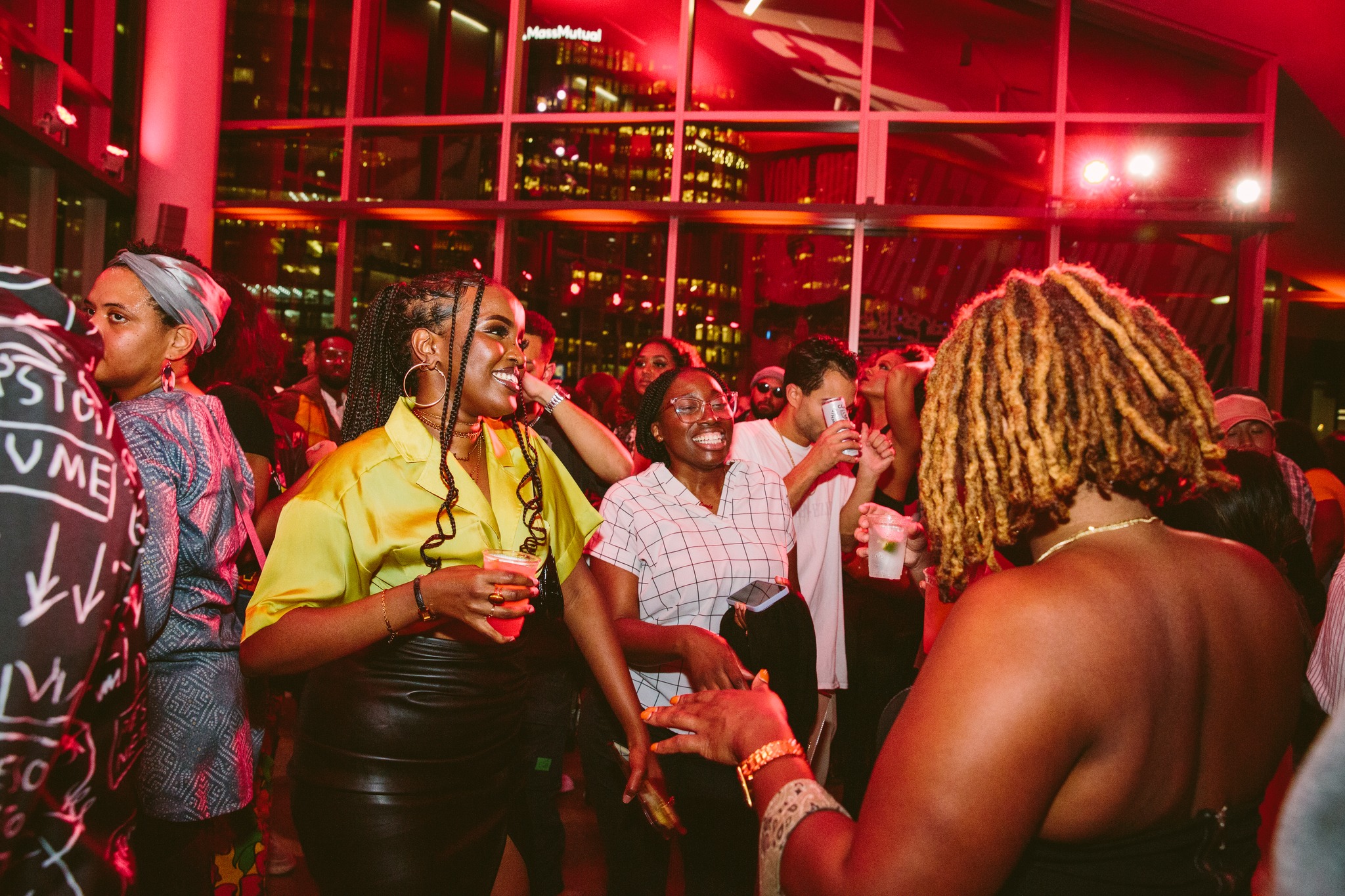 Young people dancing with drinks on the dance floor