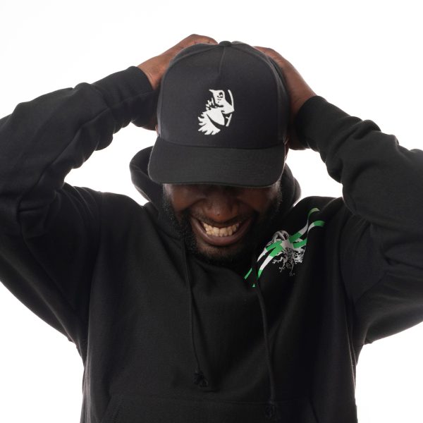 Hat with icon of a white grim reaper reaching one hand towards the viewer worn by dark skin model. 