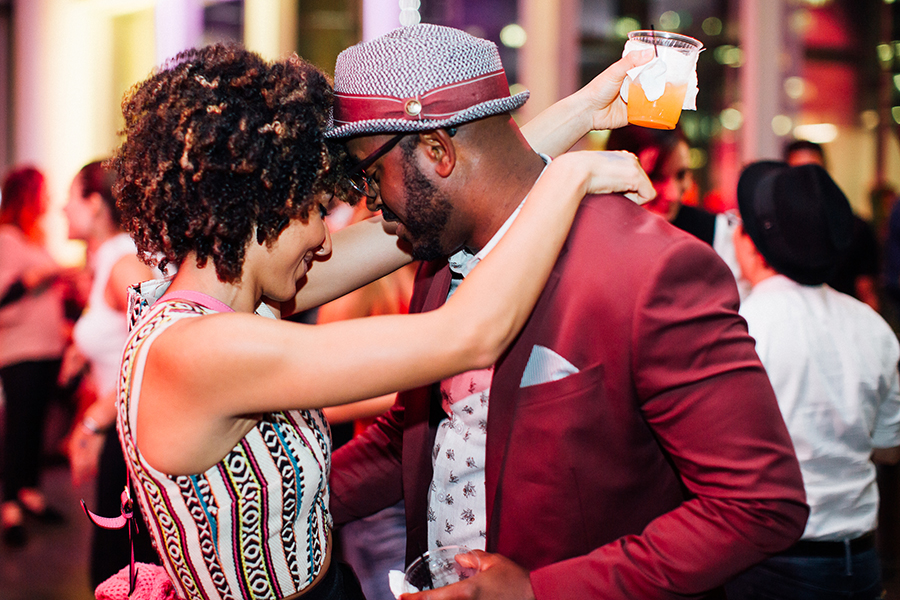 Two people wearing red dancing at First Fridays. 