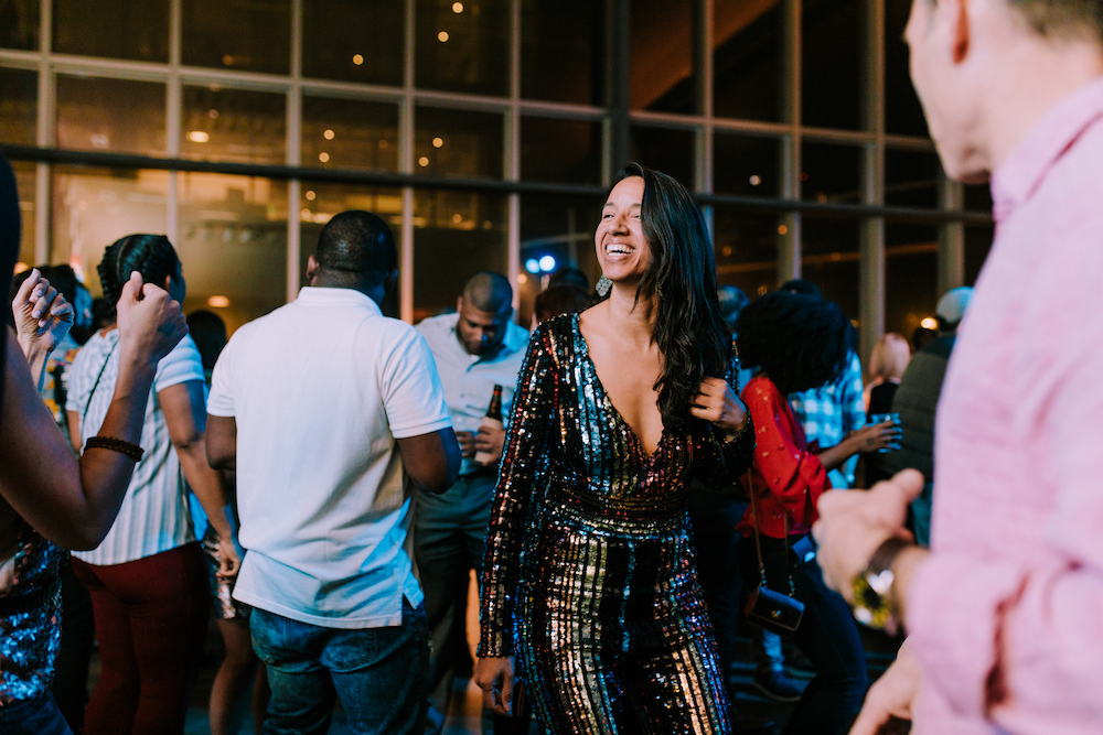 A visitor in a sequined jumpsuit on the dance floor