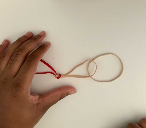 Two rubber bands chained together next to a single rubber band