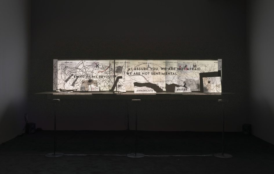 An installation shows a projection of a map with text that reads 