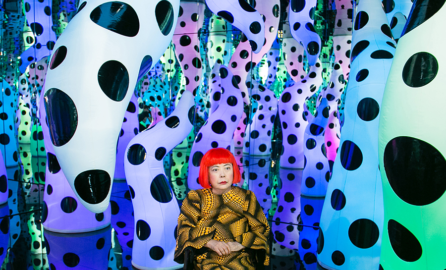 An infinity mirror room full yellow and black polka dots