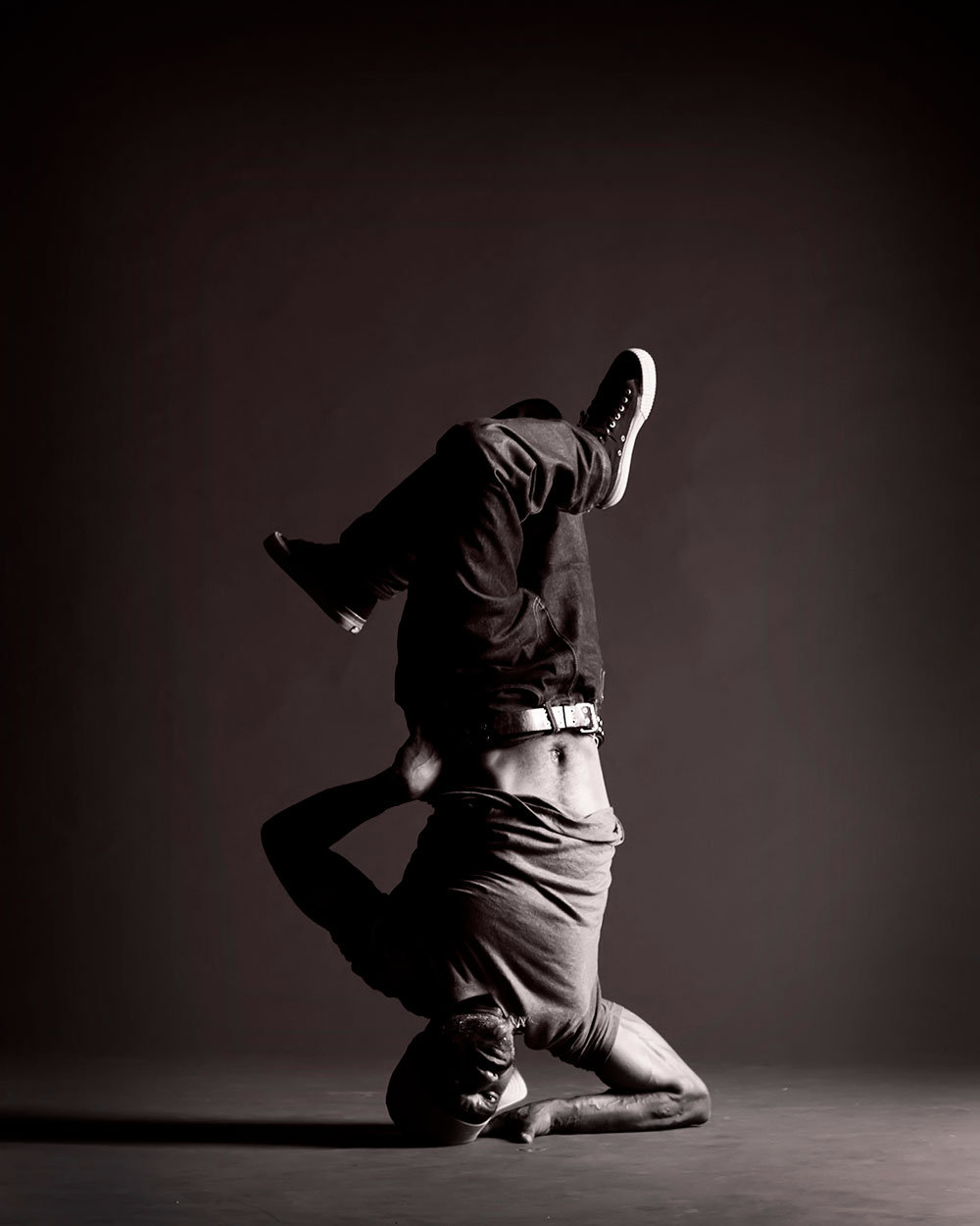 Black and white photo of man dancing upside down