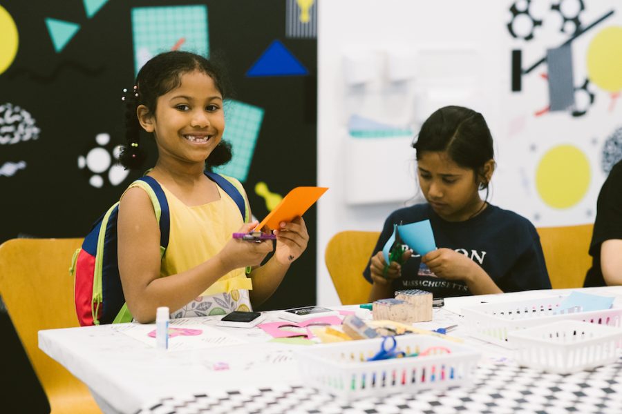 Two youths cutting up paper at the Art Lab