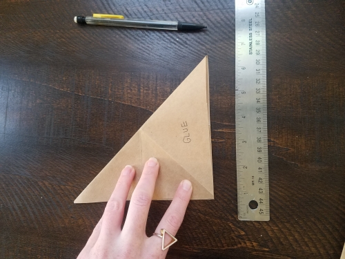 Diagonally creasing a triangularly folded piece of paper