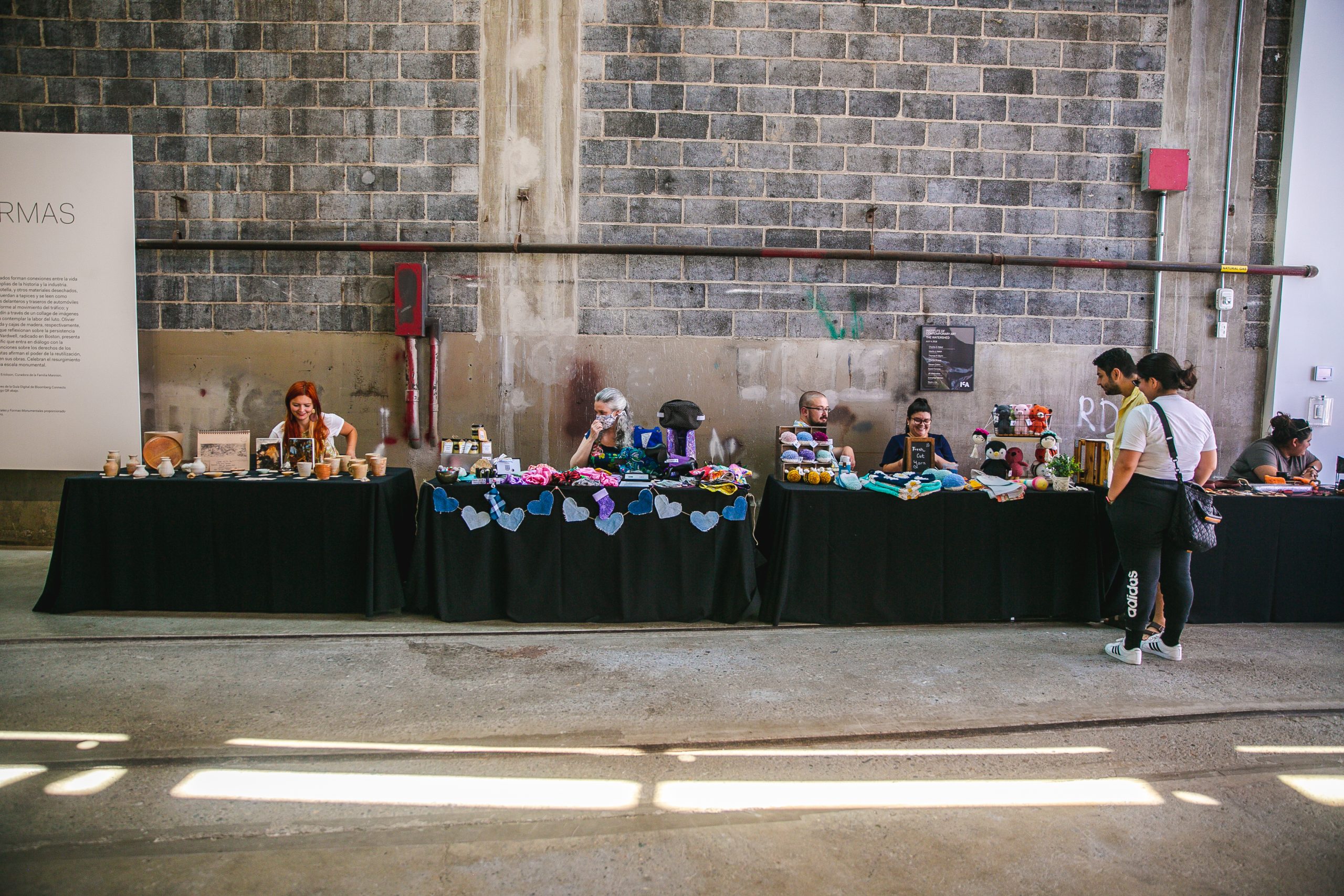 A row of vendors inside an industrial-looking space