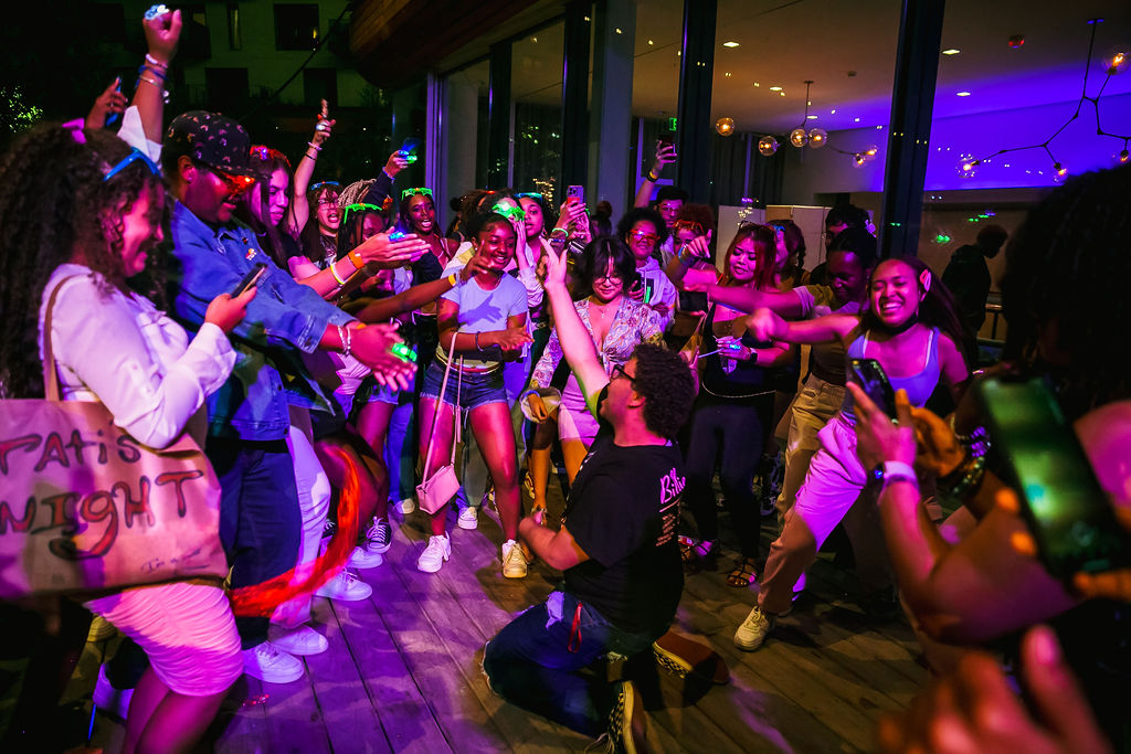 A dance circle of teenagers outside the museum