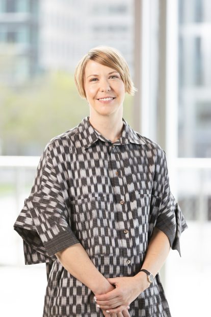 Photo of Ruth Erickson (curator) wearing a black and white dress