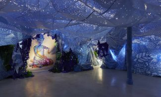 Art installation of room covered in blue tarp with holes cut through