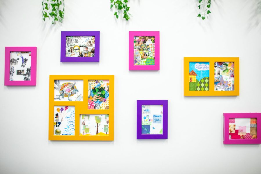 Brightly colored picture frames with 2-dimensional artworks on wall