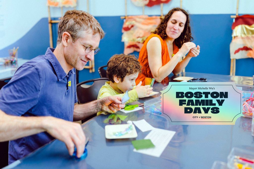 A man and woman sit at a table with a young boy working on an art project during ICA Boston Family Days, with a graphic overlay reading Mayor Michelle Wu’s Boston Family Days City of Boston.