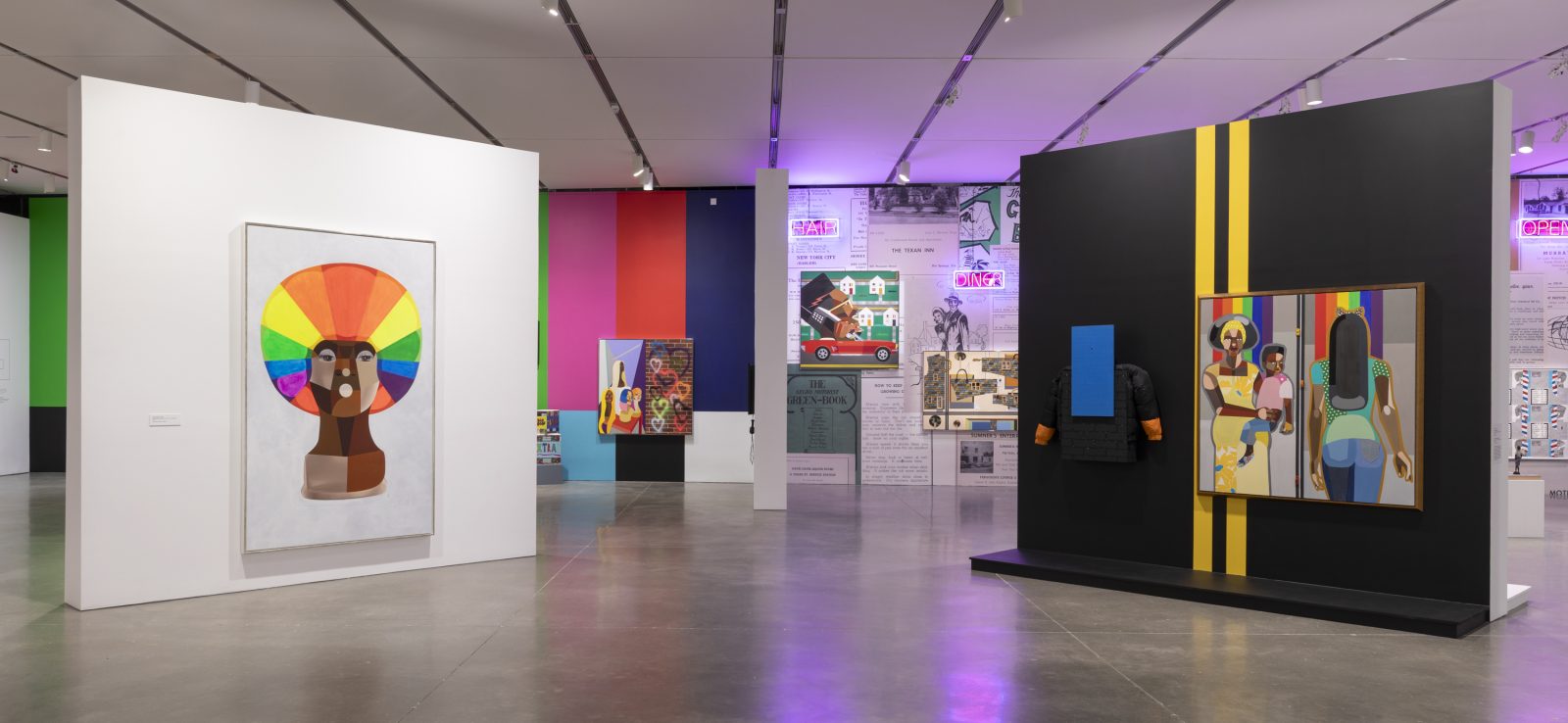 A gallery with colorful paintings and digital artworks on white and black walls, featuring bright paintings, wallpapered walls, and neon lighting on one side