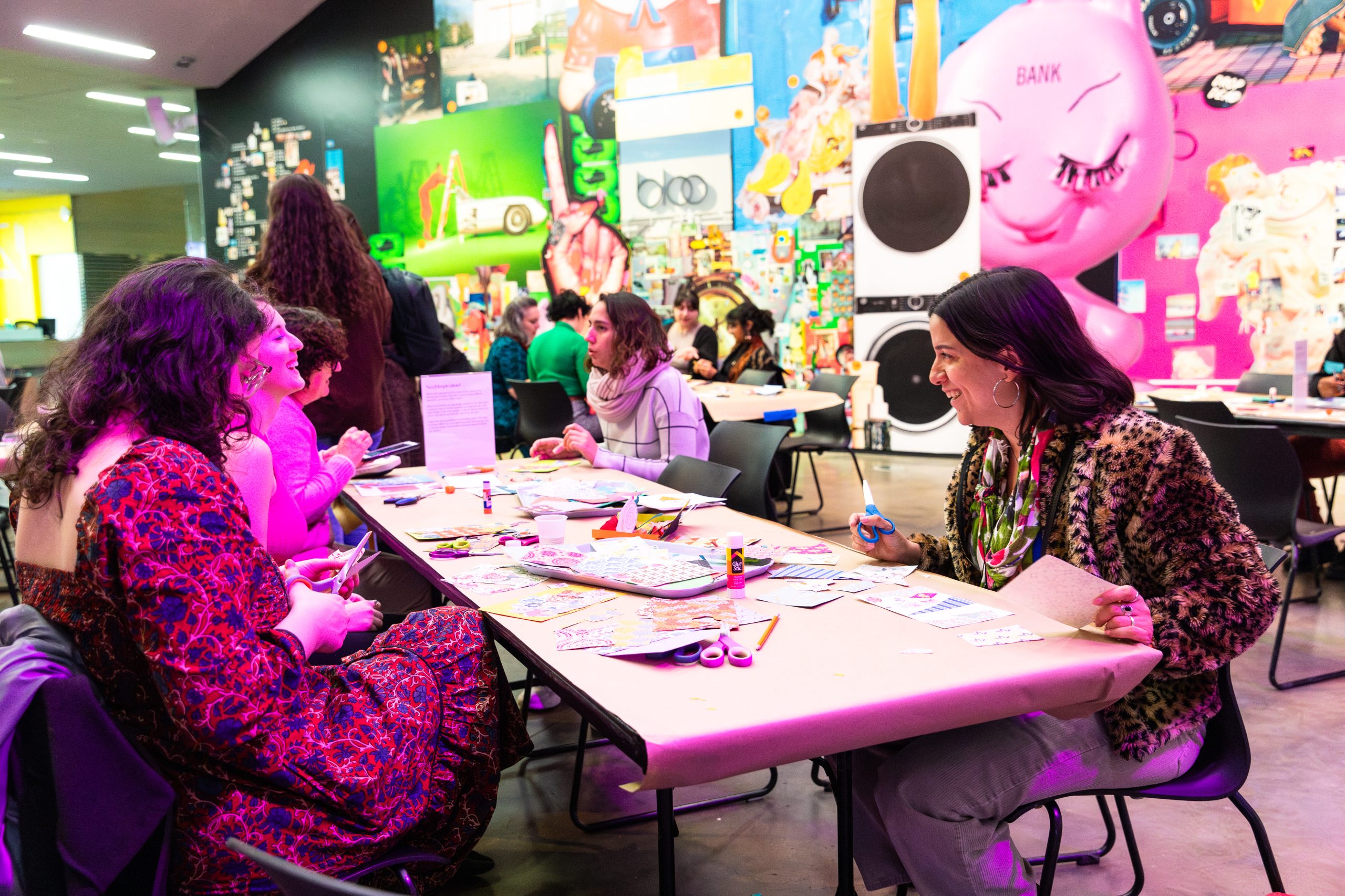 A group of people craft at a long table