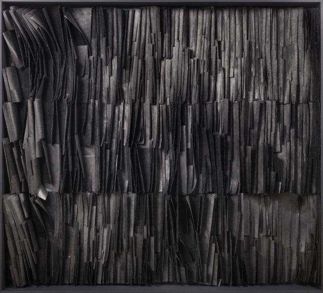 A square frame filled with densely packed, vertically arranged, overlapping black strips