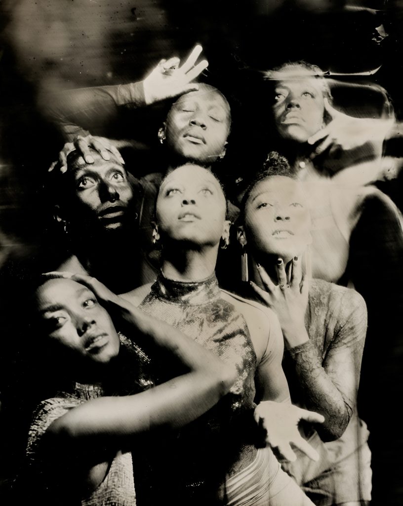 Five people pose dramatically in a black-and-white, artistic photo for Shamel Pitts TRIBE Marks of Red.