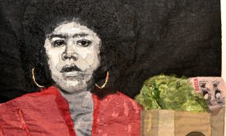 A textile artwork depicts a woman with an afro, gold hoop earrings, and a red top, holding a brown grocery bag containing lettuce and currency, set against a dark background.